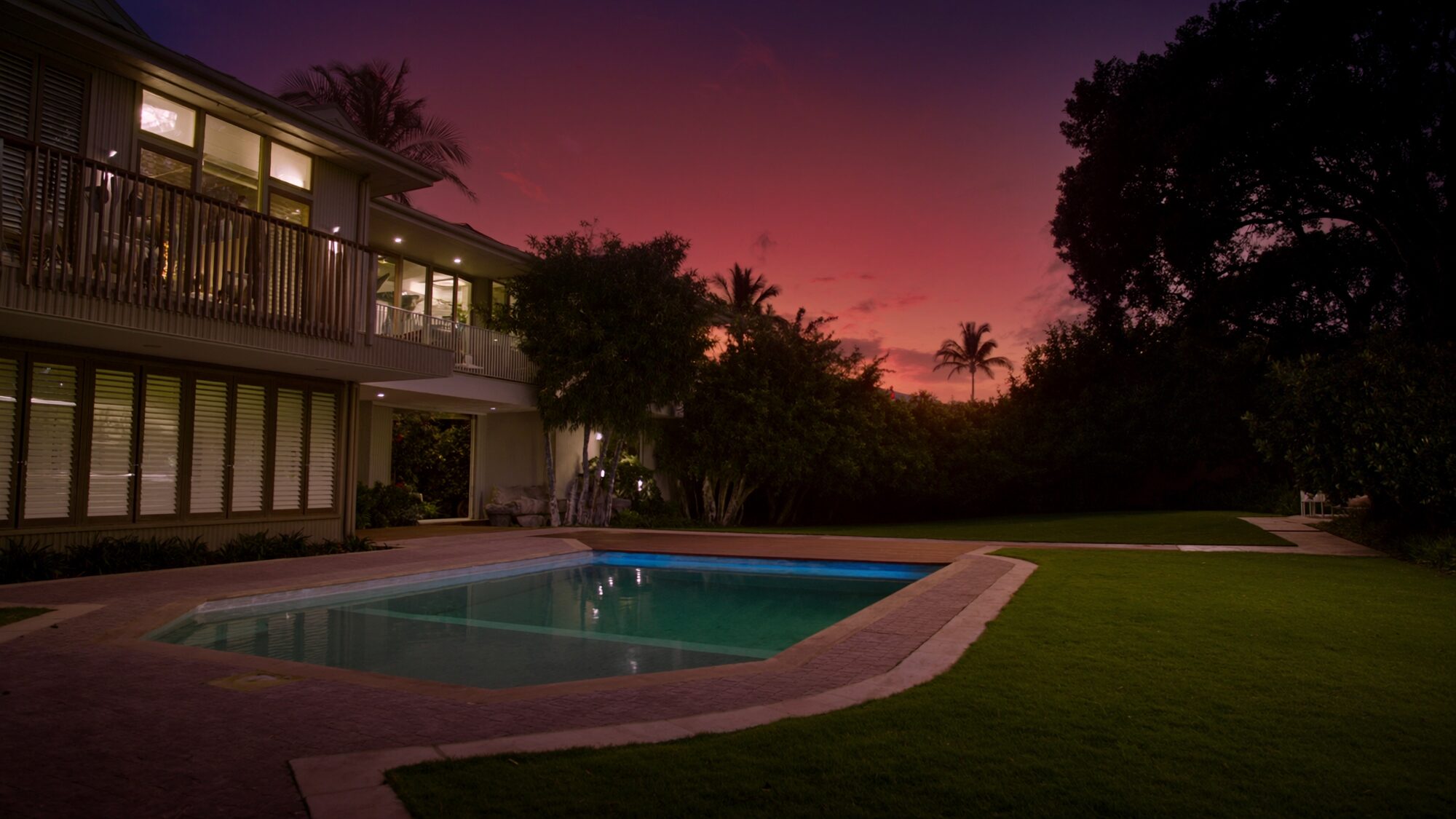 A styled Darwin home with a pool and verandah glowing in the late afternoon light, the kind of property Advanced Stays runs as a managed short stay