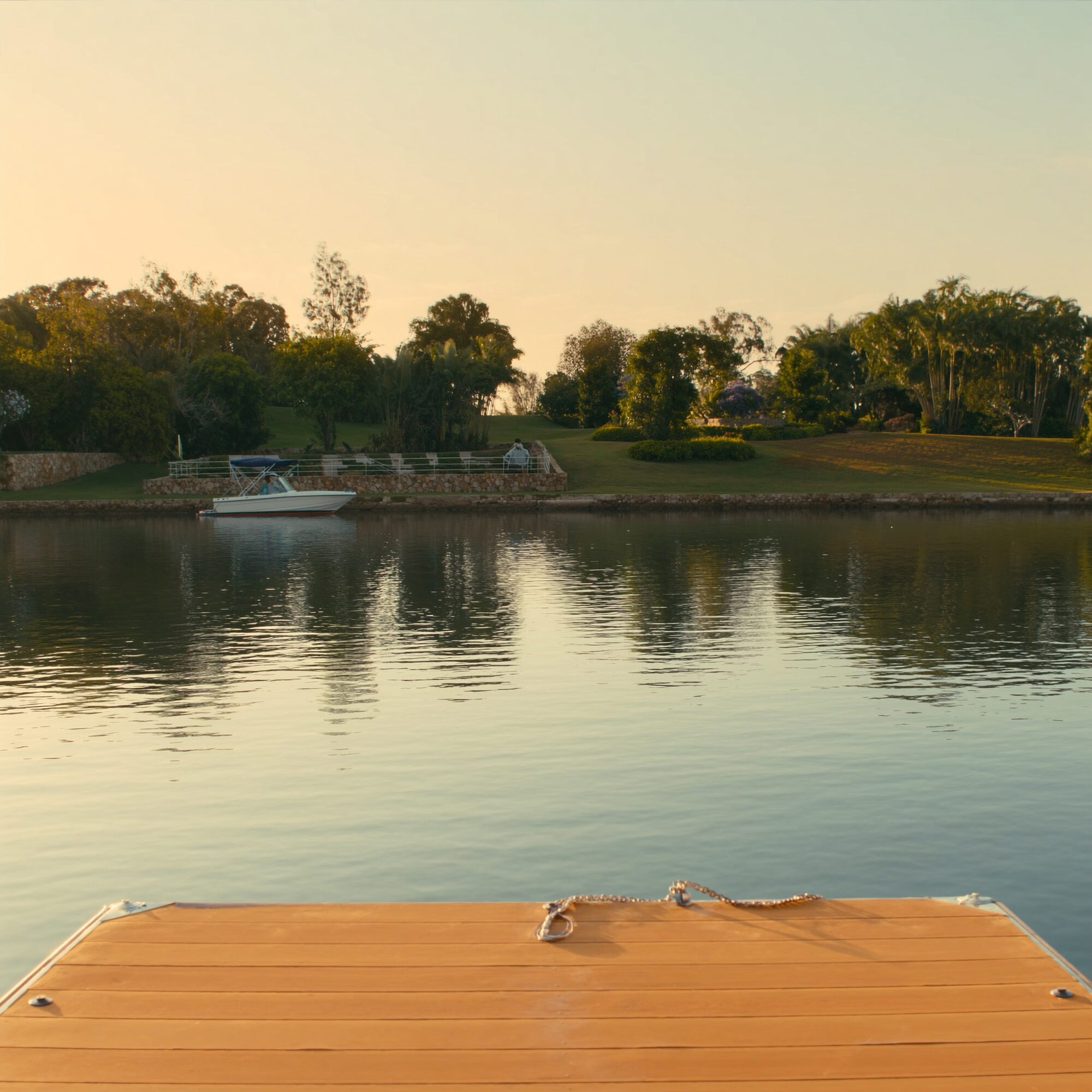 Calm Bayview canal frontage with the villa's private pontoon reaching to the water