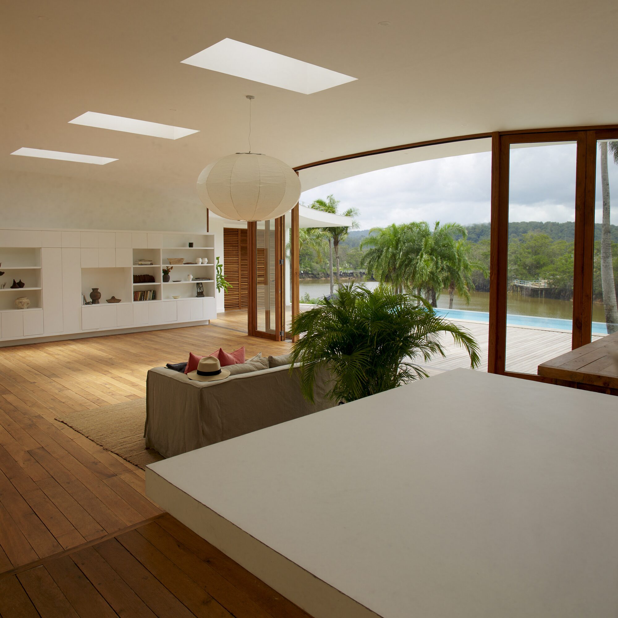 Open-plan living room of the villa opening straight onto the pool deck