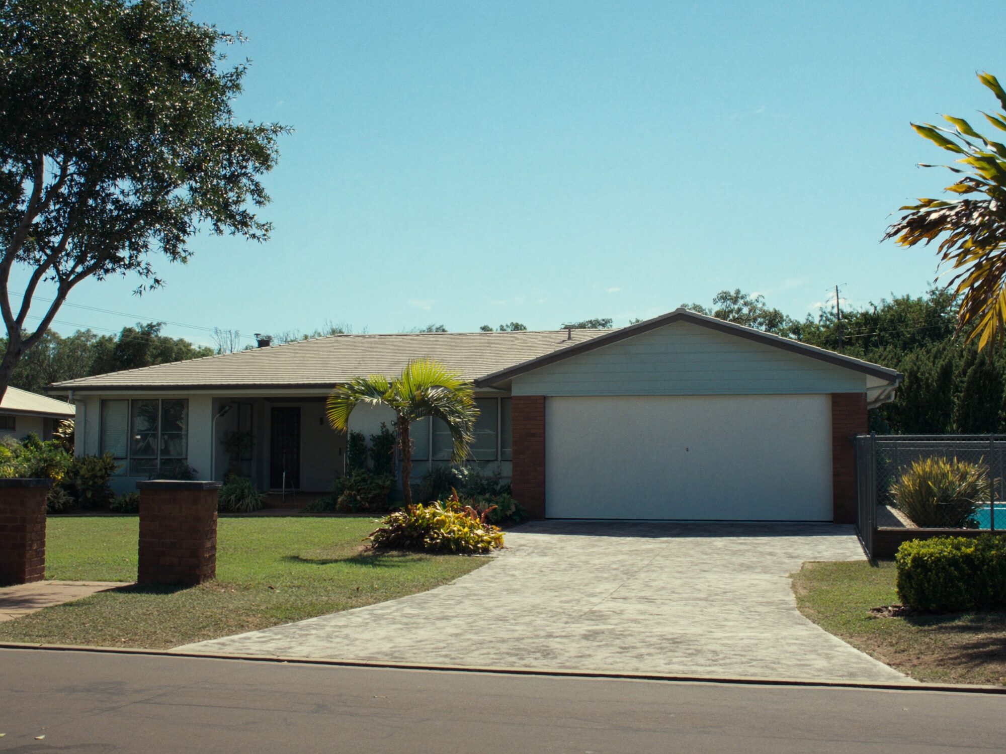 Modern single-storey Palmerston family home with a tidy lawn and double garage