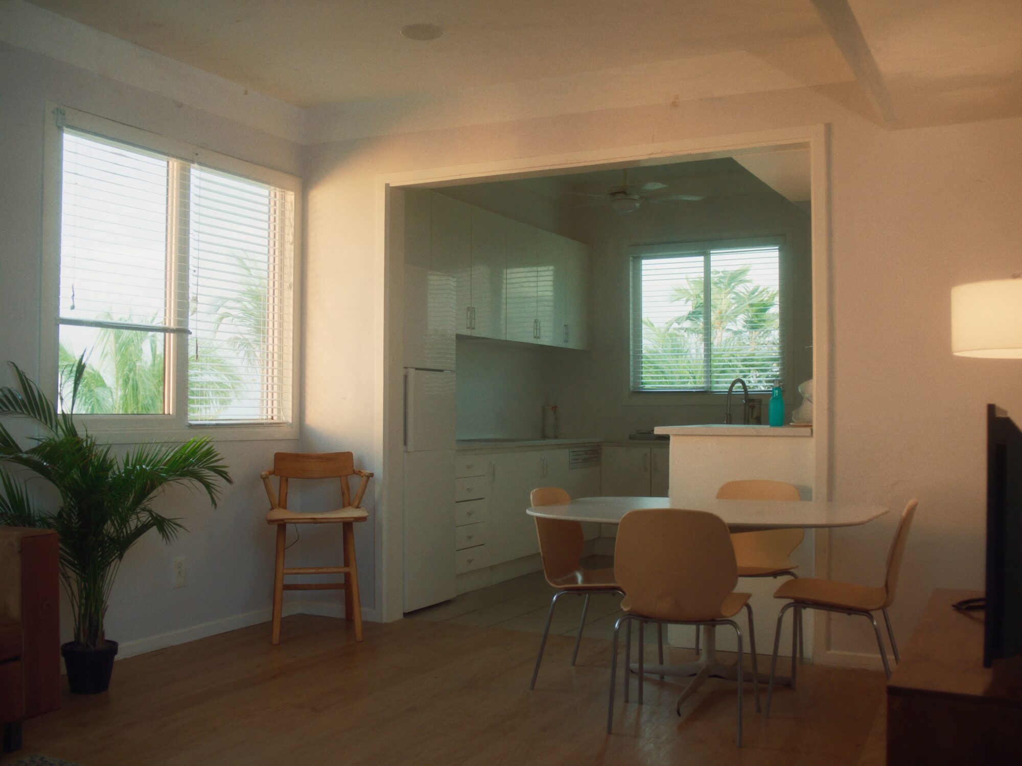 Tidy Rapid Creek coastal unit interior with louvre windows and soft afternoon light